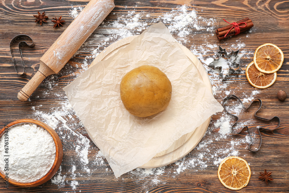 Composition with raw dough, ingredients and utensils for preparing Christmas cookies on wooden background