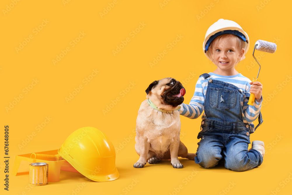 Little decorator with paint roller and cute pug dog on yellow background