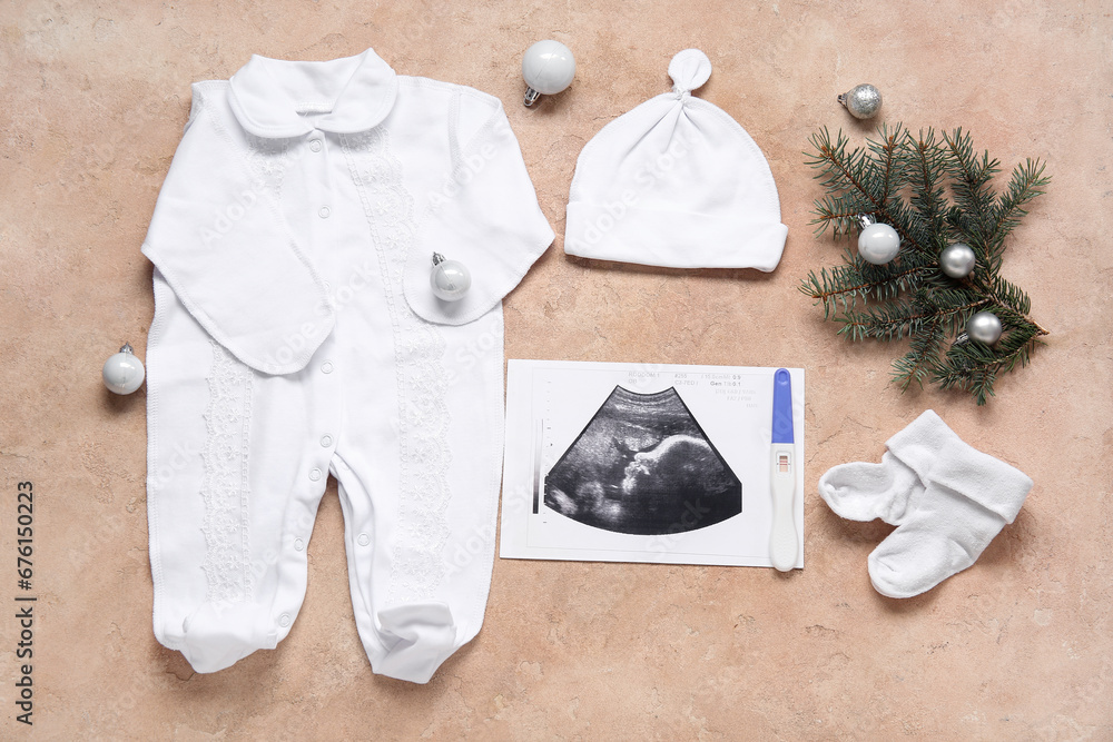 Composition with sonogram image, baby clothes and Christmas decorations on color background