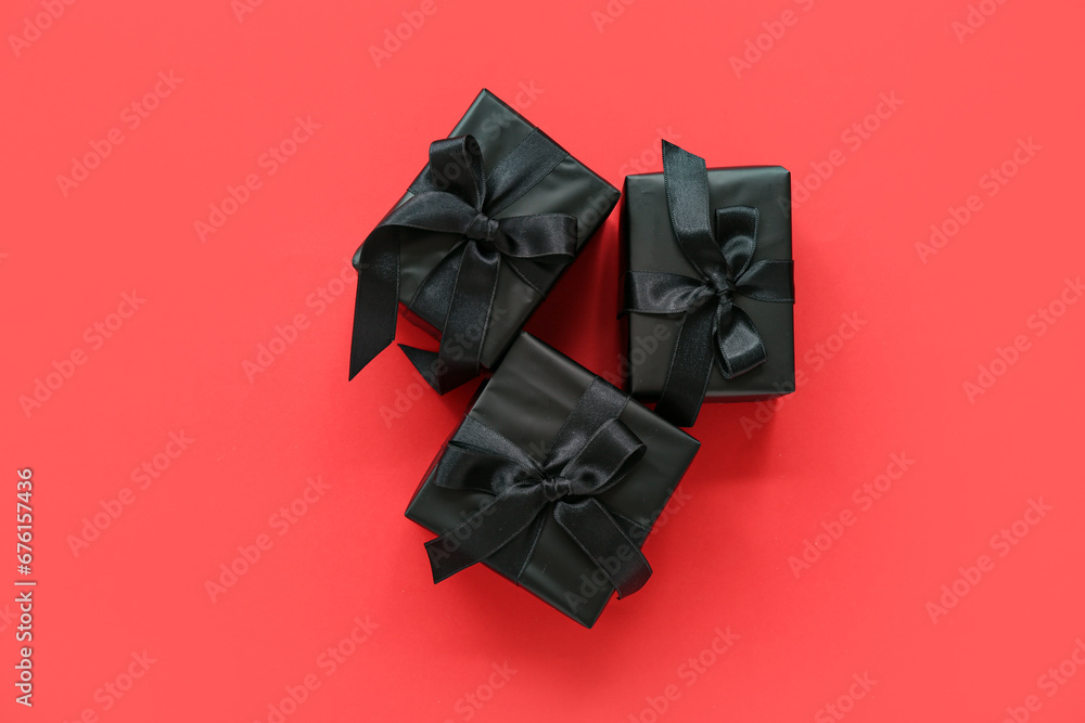 Black gift boxes on red background