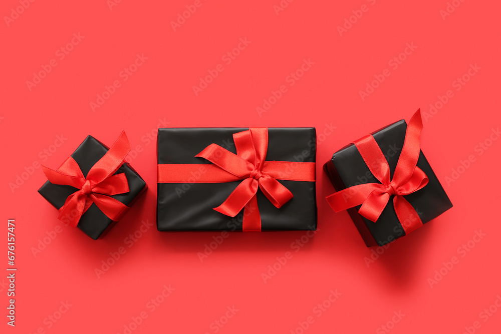 Gift boxes on red background. Black Friday