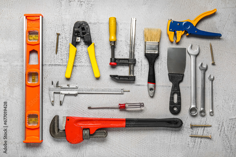 Set of construction tools on grey background