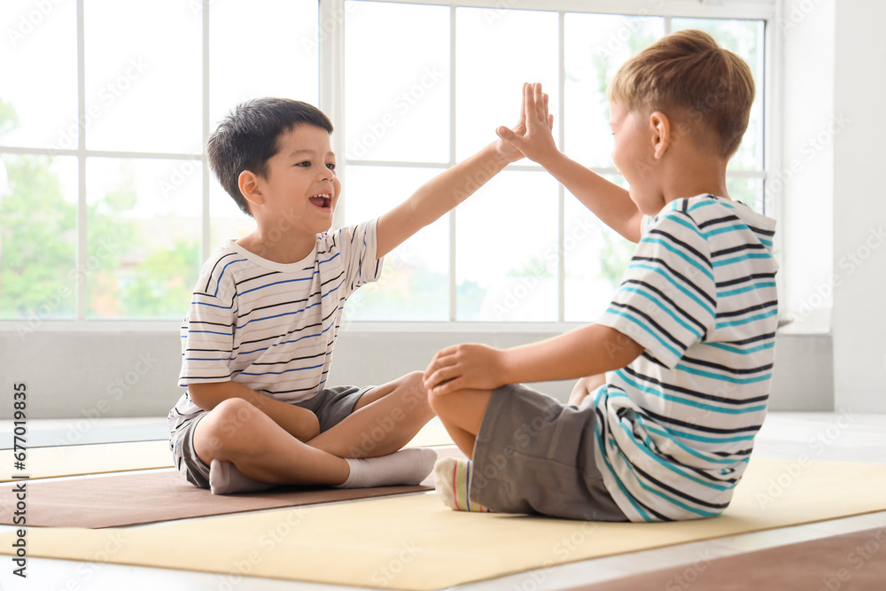 Little boys doing yoga in gym