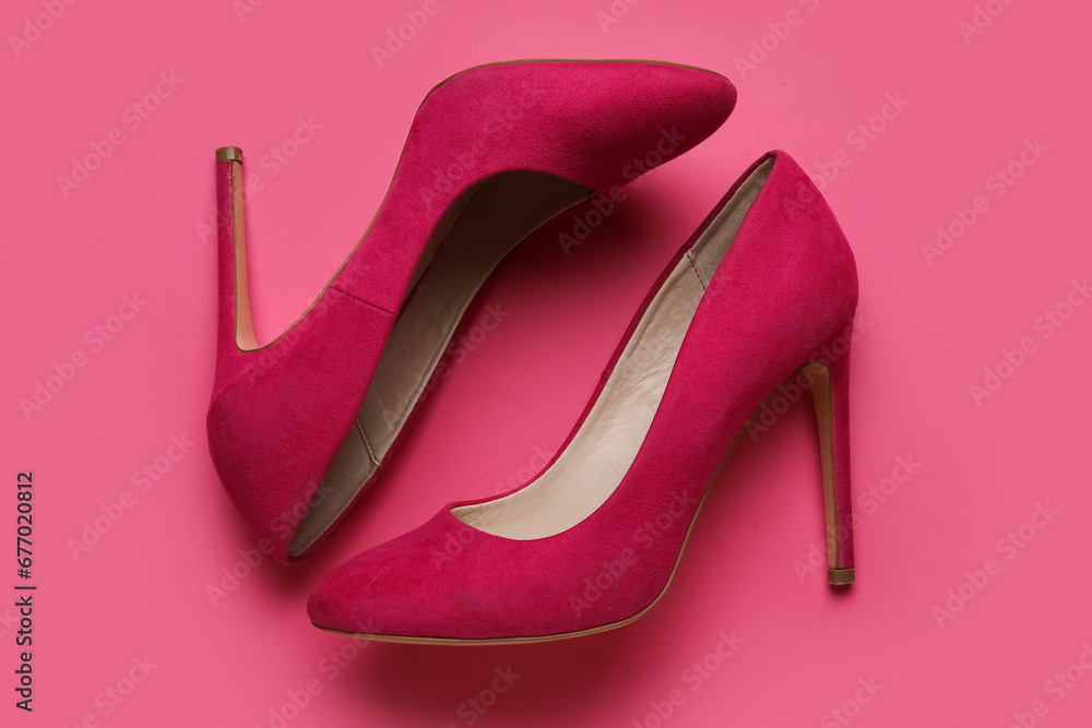 Stylish pink high heels on color background