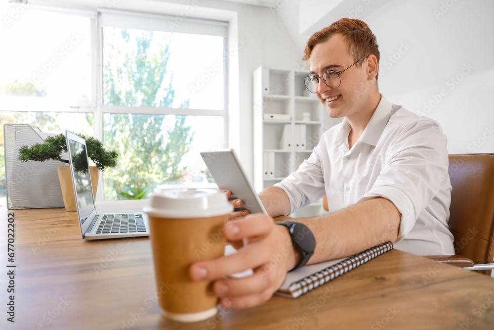 Young businessman working with tablet computer in office