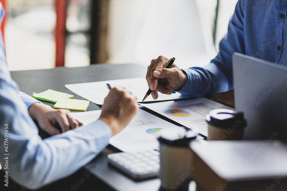 Meeting of financial advisors to discuss and analyze the graph growth in the business chart report to plan marketing and investment strategies.