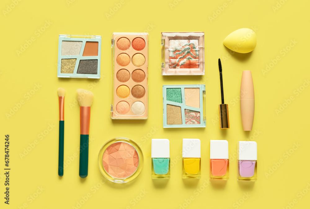 Different decorative cosmetics on yellow background