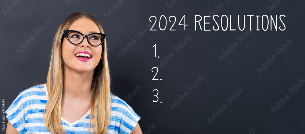 2024 Resolutions with happy young woman in front of a blackboard