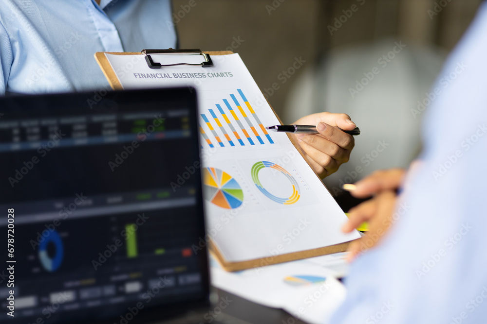 Meeting of financial advisors to discuss and analyze the graph growth in the business chart report to plan marketing and investment strategies.