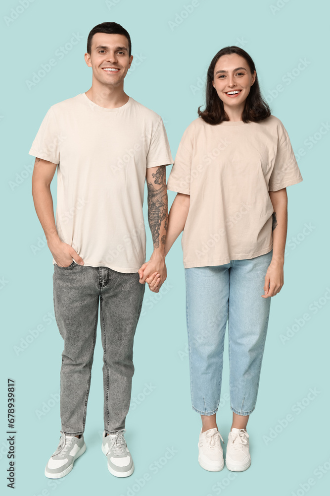 Young couple holding hands on blue background