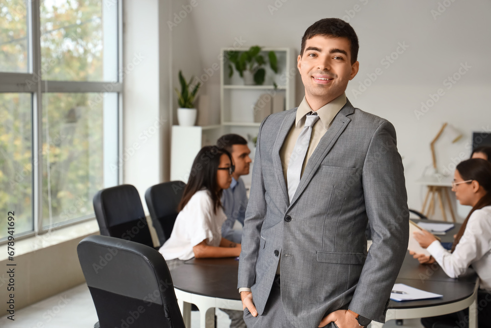 Young businessman smiling in office