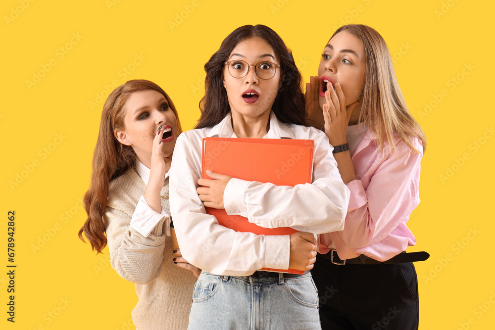 Business colleagues gossiping on yellow background