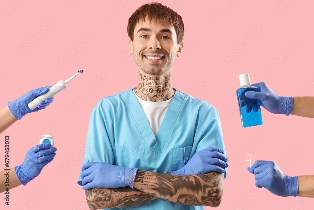 Male dentist and hands with set for oral hygiene on pink background