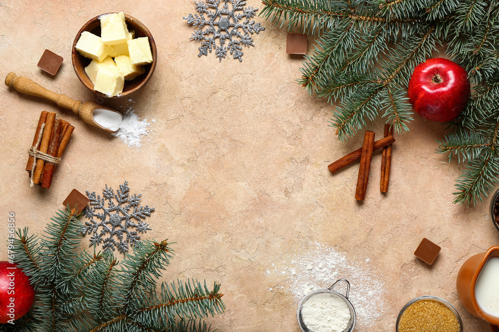 Frame made of different ingredients for preparing Christmas pie and fir branches on beige background