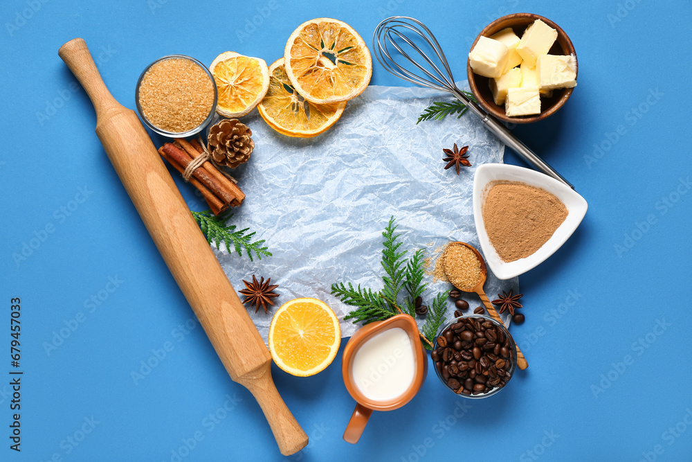 Different ingredients for preparing Christmas pie on blue background