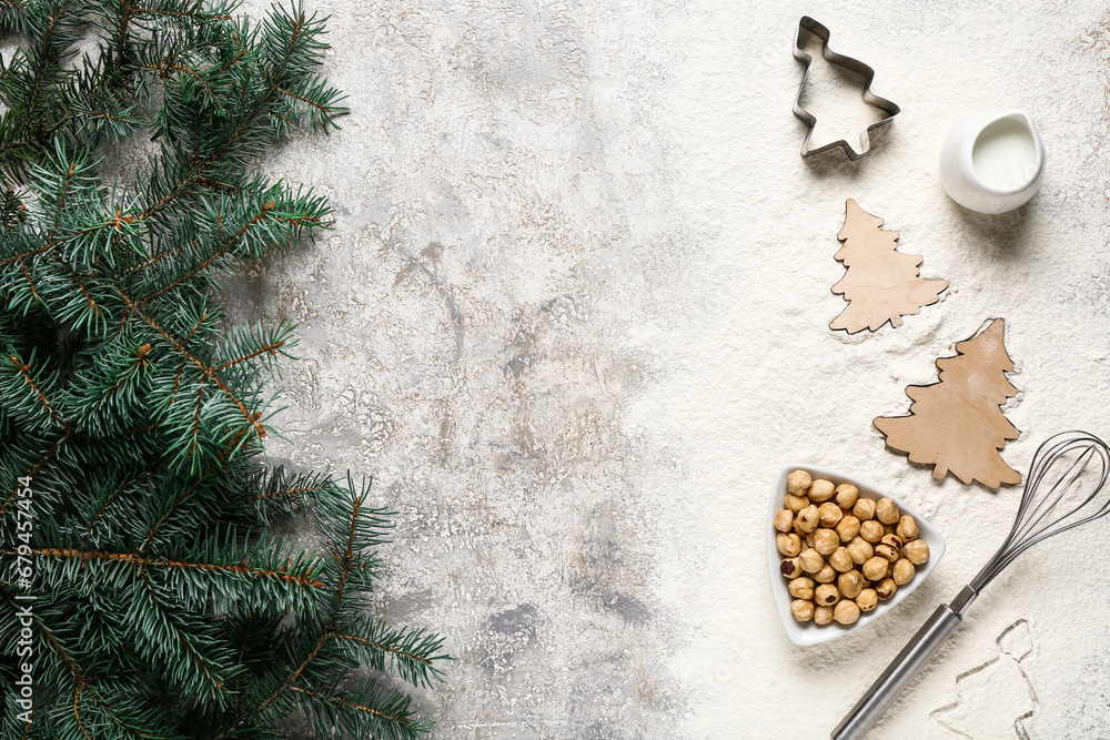 Frame made of different ingredients for preparing Christmas pie and fir branches on grey background