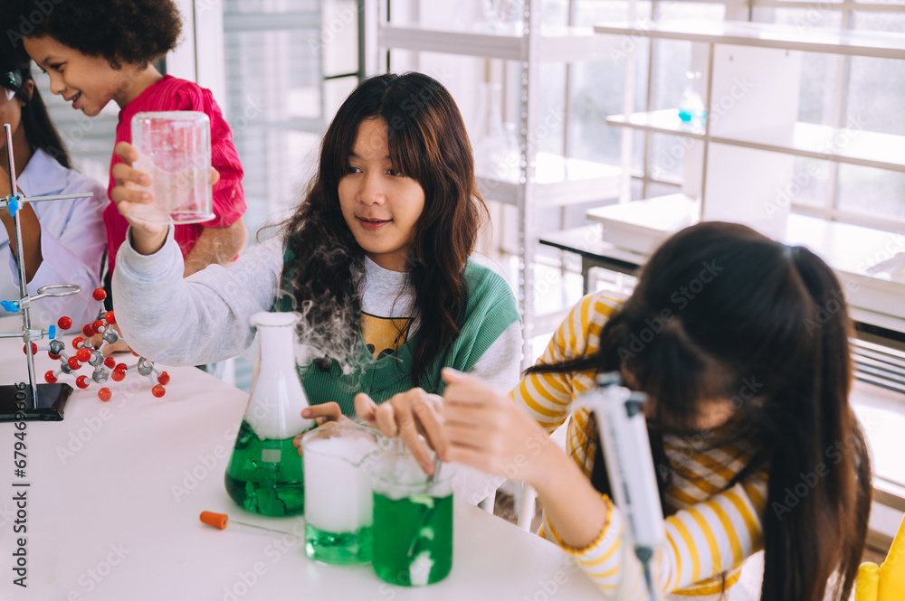 Group of women and men working together. Children in white play as scientists in a laboratory using equipment.