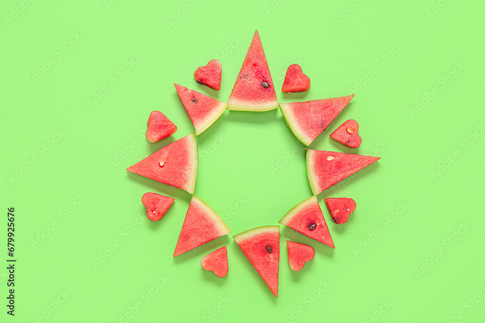 Frame made of fresh watermelon on green background