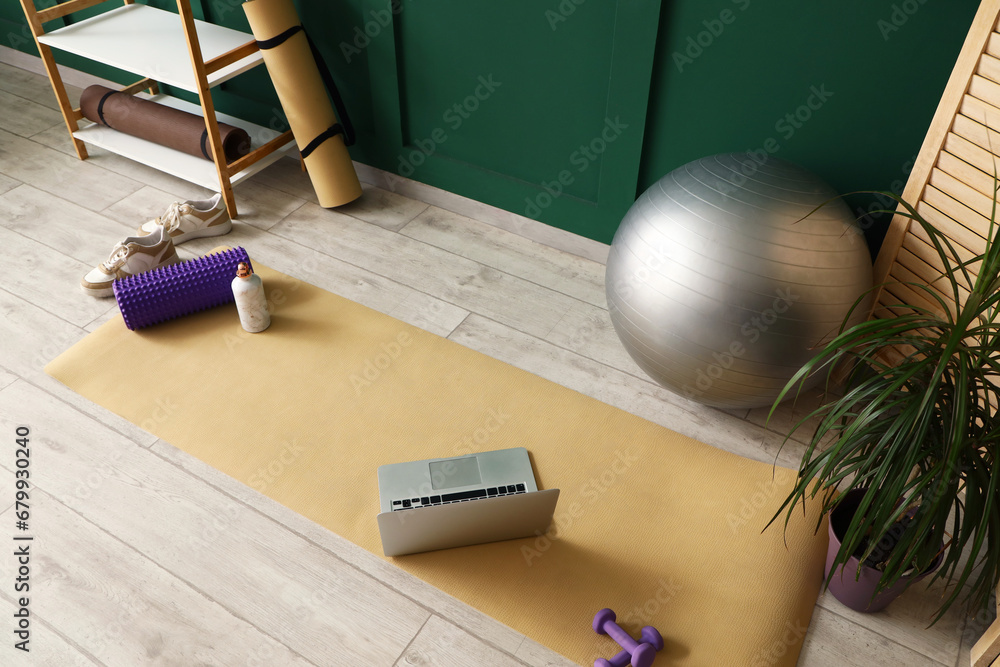 Interior of room with sports equipment and laptop