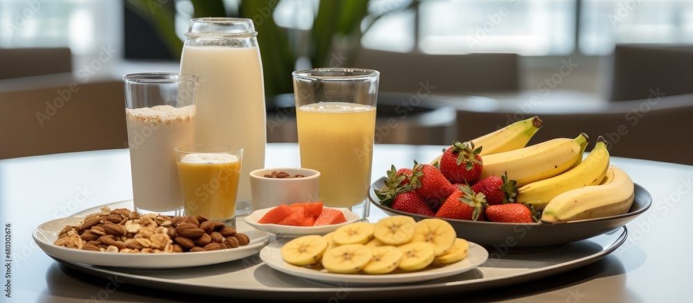 On the table, a healthy breakfast spread awaited, featuring an array of nutrient-rich foods such as yogurt, fruit, organic chocolate, and a glass of refreshing juice made with natural ingredients