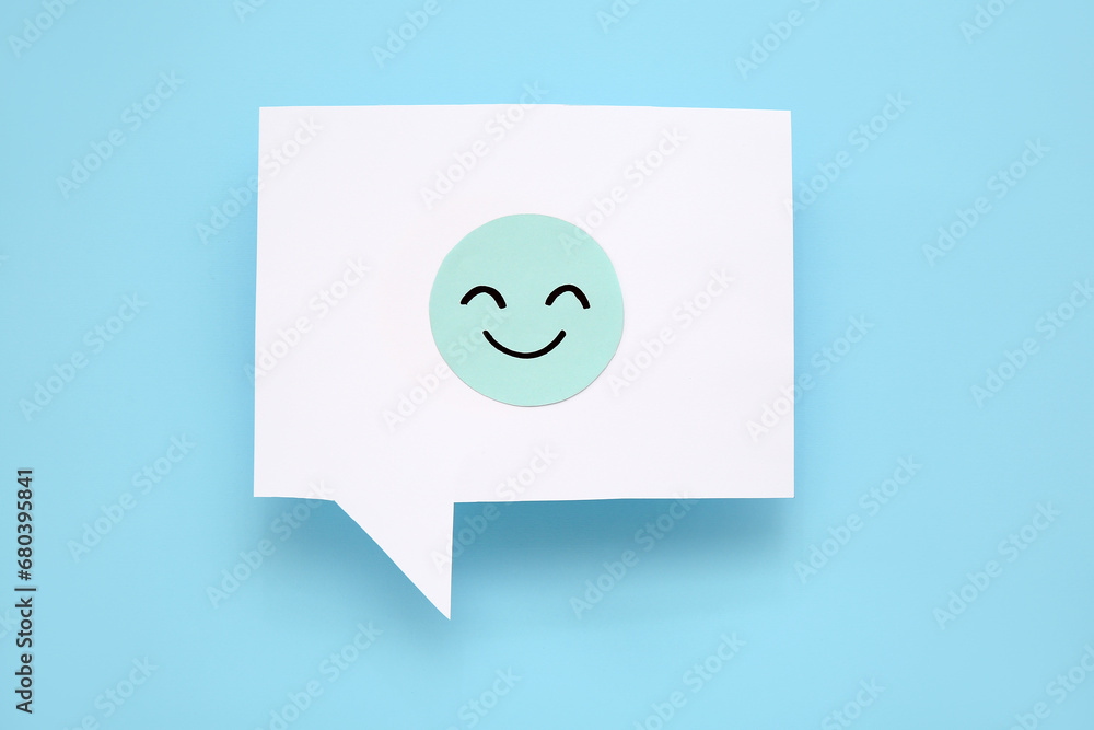 Speech bubble with happy face on blue background