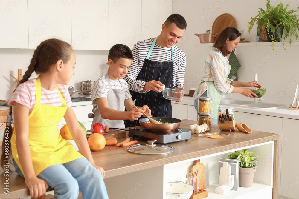 Happy family cooking in kitchen