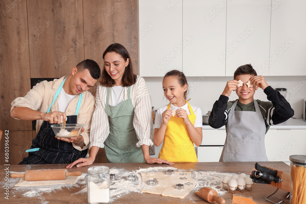 Happy family making cookies in kitchen