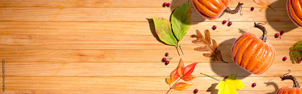 Autumn pumpkins with colorful leaves overhead view - flat lay