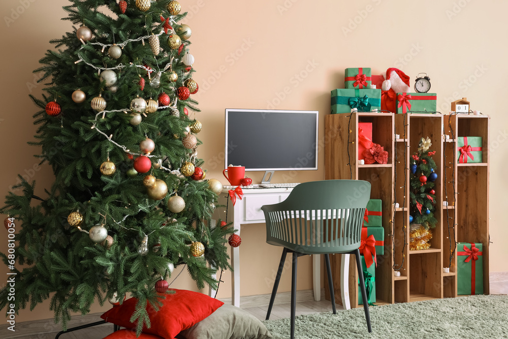 Interior of office with workplace, computer monitor and Christmas presents