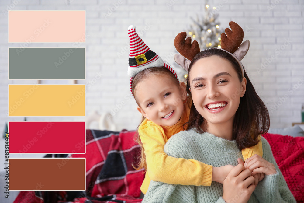 Happy mother and her little daughter at home on Christmas eve