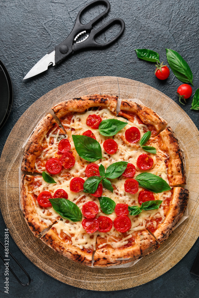 Wooden board with tasty pizza Margarita on black background