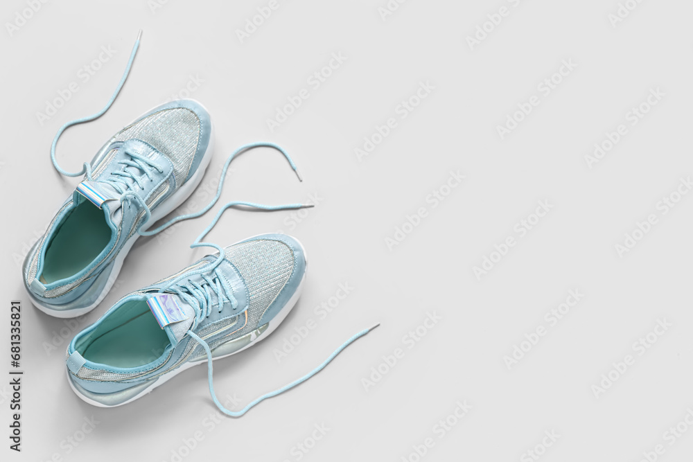 Stylish blue sneakers on grey background