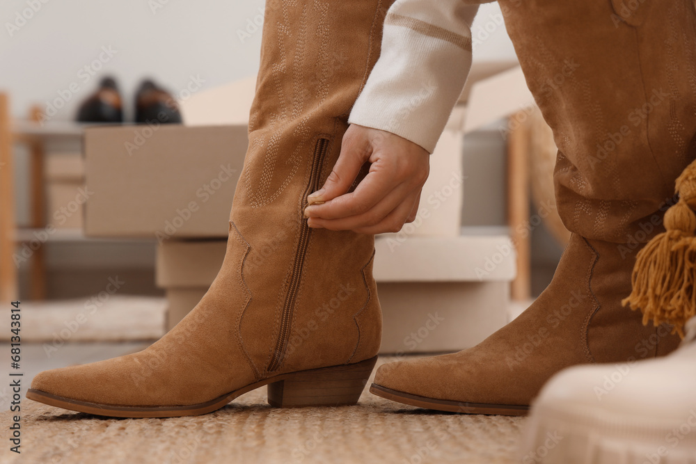 Woman trying on stylish leather shoes in boutique, closeup