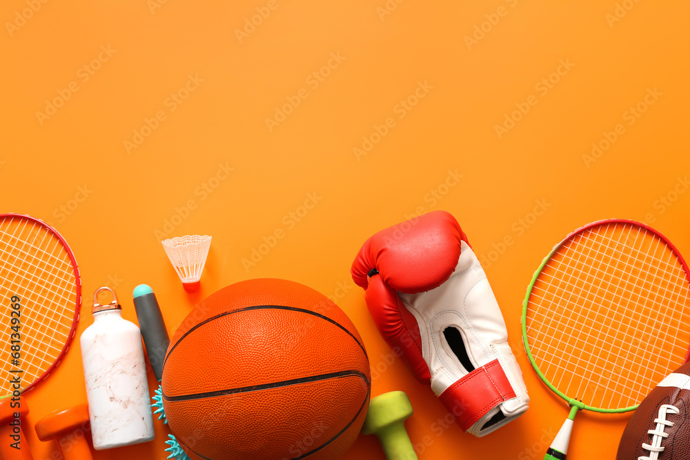 Different sports equipment on orange background