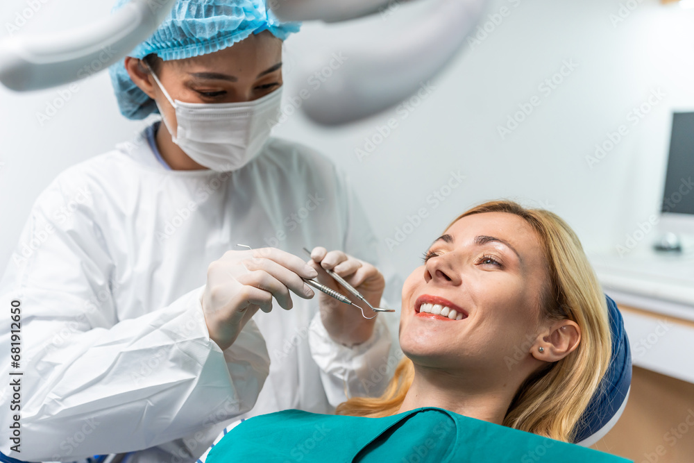 Female dentist examine tooth to Caucasian girl at dental health clinic. 