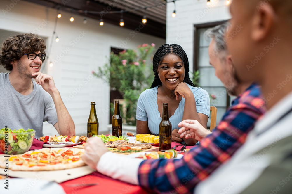 Multi-ethnic family having fun, enjoy party outdoors in the garden. 