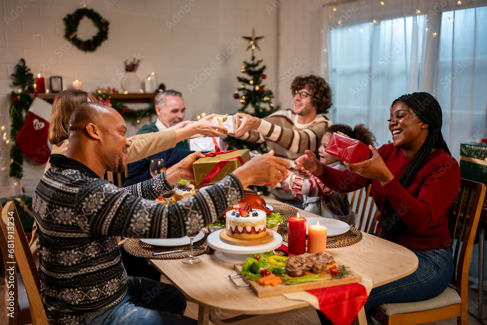 Multi-ethnic family exchanging presents during Christmas party at home. 