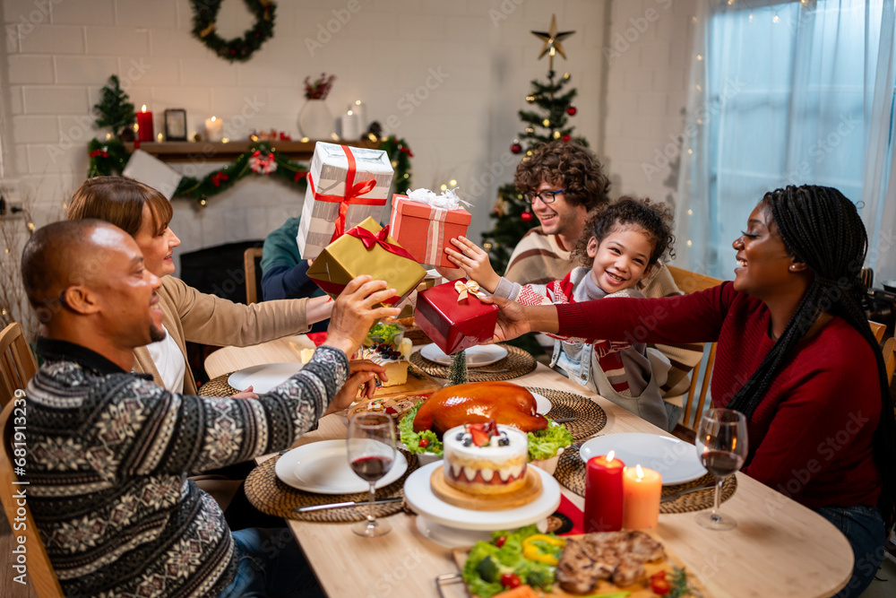 Multi-ethnic family exchanging presents during Christmas party at home. 