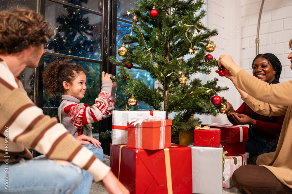 Caucasian family and kid daughter decorating Christmas tree in house. 