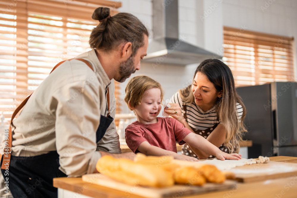 Caucasian attractive couple baking bakery with son in kitchen at home. 