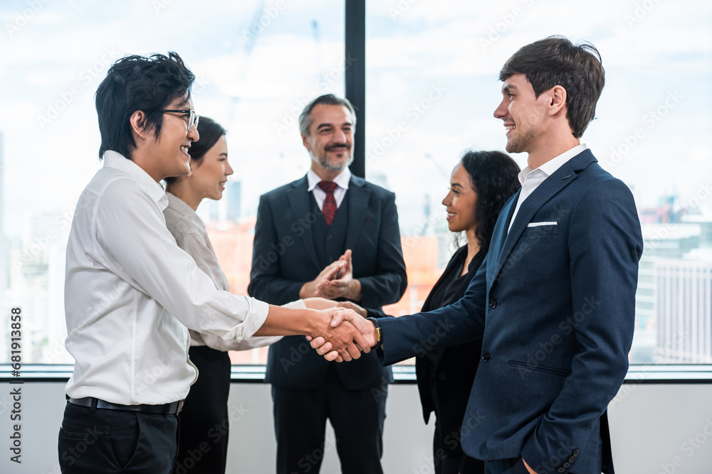 Caucasian businessman making a handshake together while stand in office. 