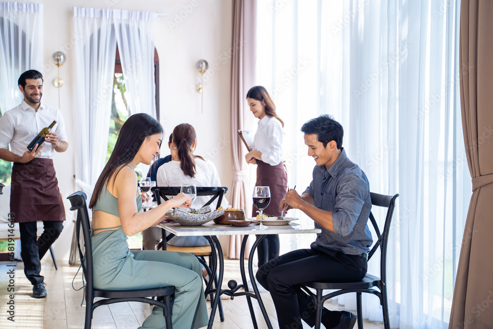 Asian young lovely couple customer having dinner in restaurant together. 