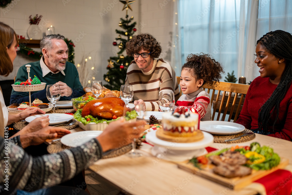 Multi-ethnic big family celebrating Christmas party together in house. 