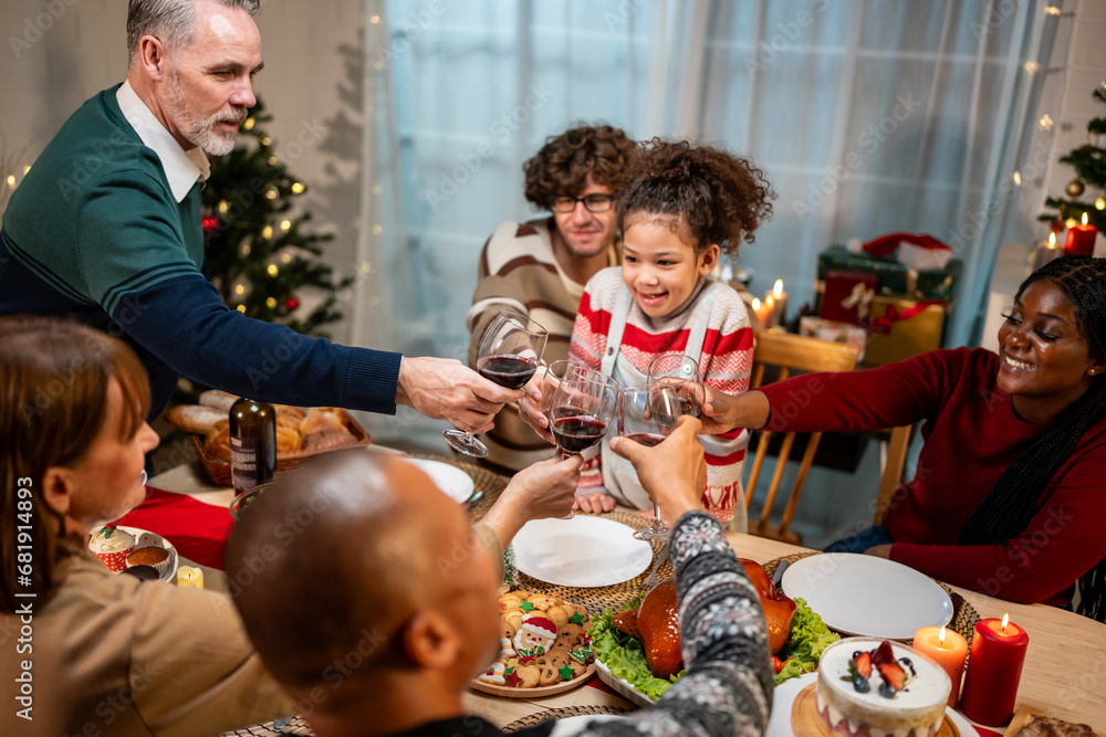 Multi-ethnic big family celebrate Christmas party together in house. 