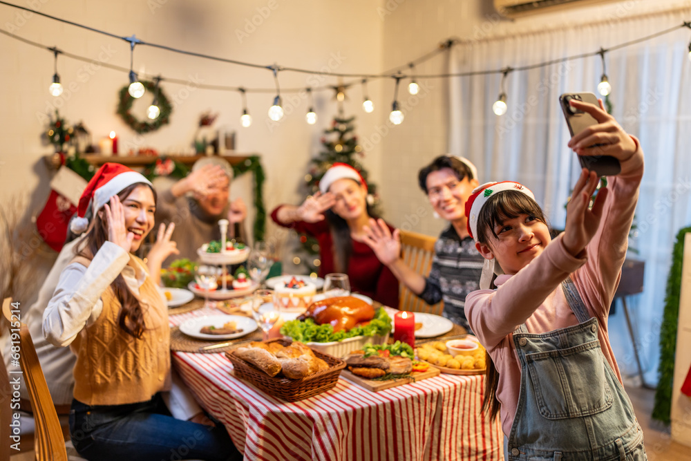 Asian family taking a photo while celebrate Christmas party together. 