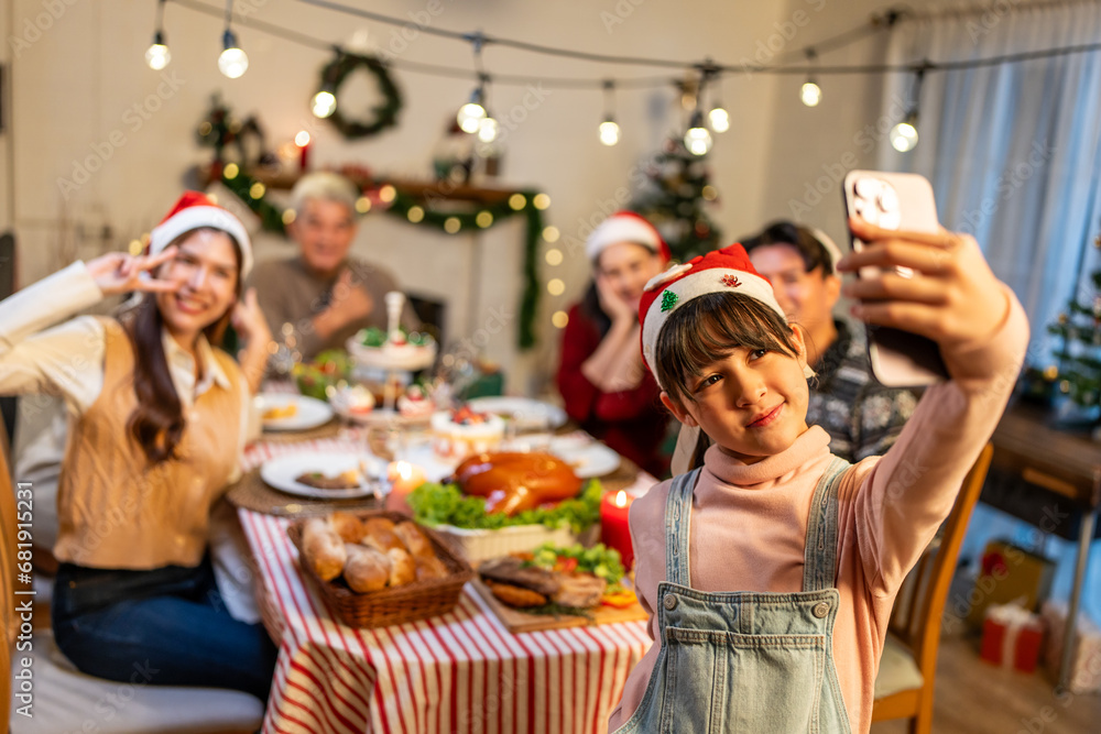 Asian family taking a photo while celebrate Christmas party together. 