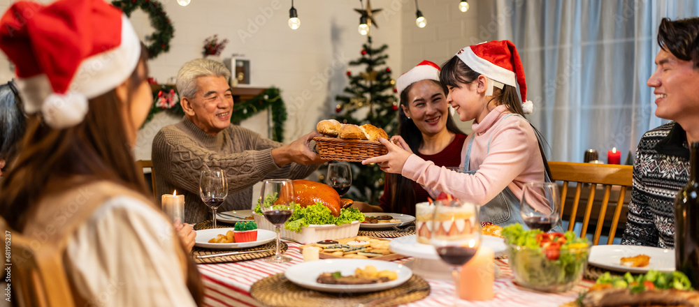 Asian lovely family celebrating Christmas party together in house. 