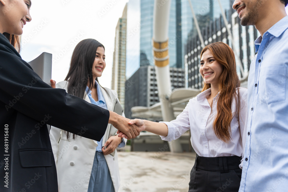 Group of Asian businesswoman making handshake outdoor in the city. 