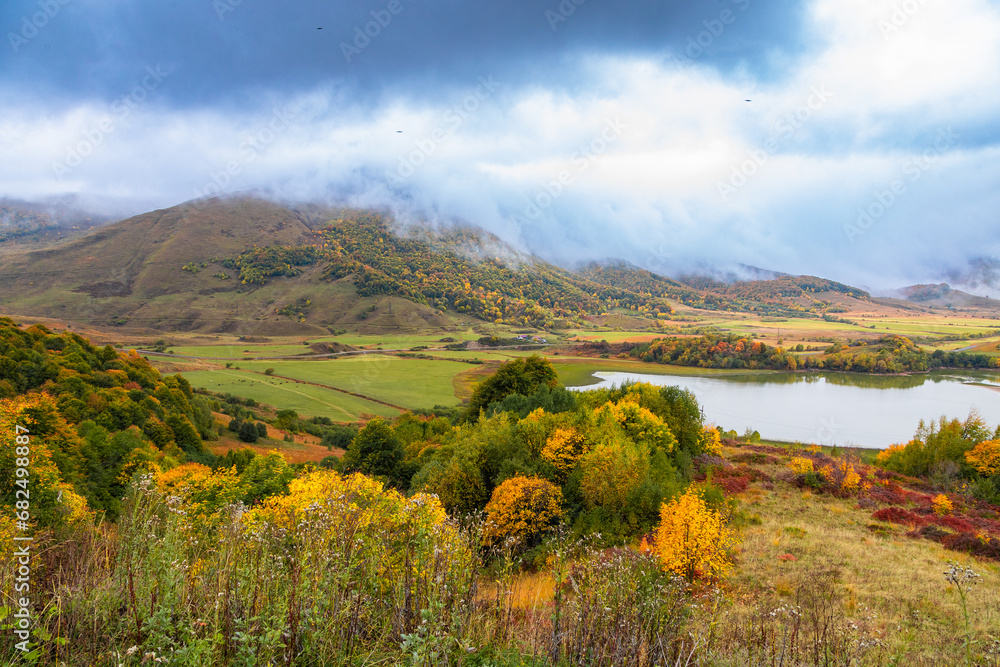 Thick clouds slide down from the mountains and are swirled by the wind.